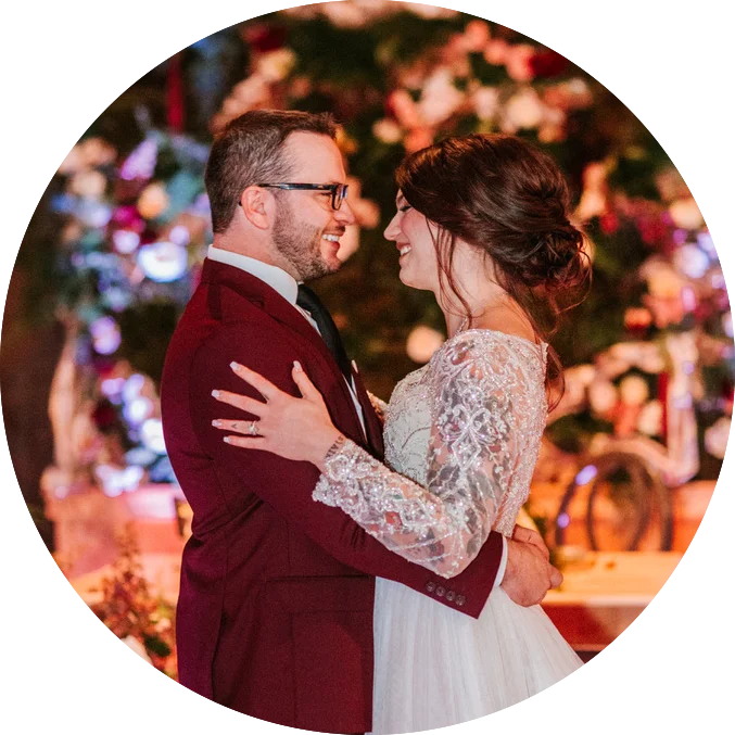 A bride and groom embracing in front of a Maine DJs.