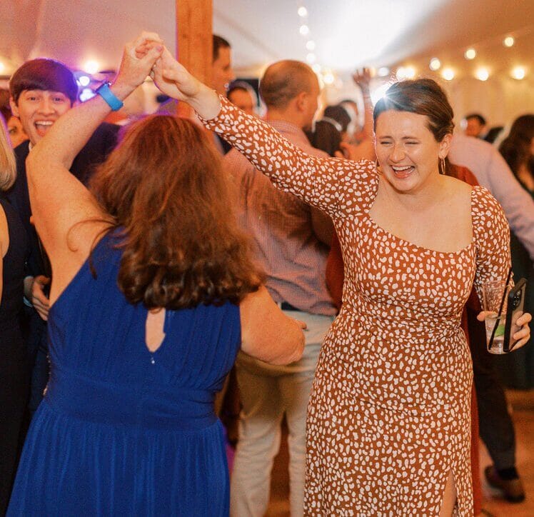 Maine DJs bringing the celebration to life with lively dancing at a tented wedding in New England.