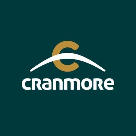 Cranmore logo with a gold letter “C” above a white curved line and the word “cranmore” in white on a dark green background.